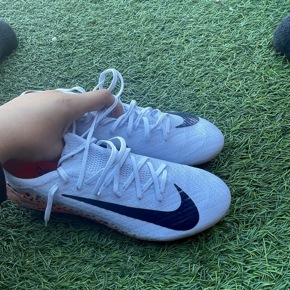 Nike White Kids Sneakers with Black Swoosh and Orange Heel Detail